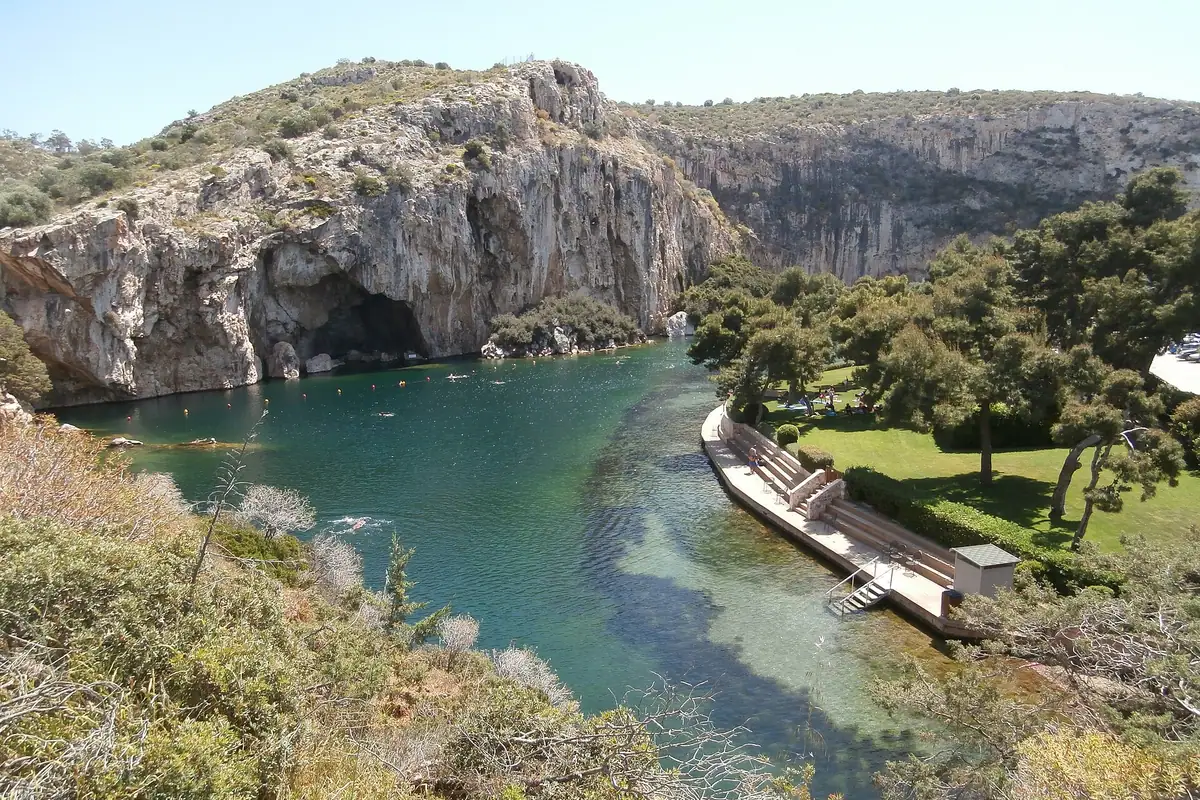 Lake Vouliagmeni: a collapsed cave, fed by thermal springs, a hundred metres from the sea.